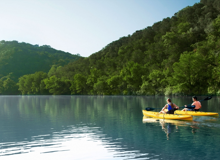 A canoeing couple in Lake Austin Spa Resort
