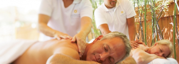 A man and woman lay down and relax as they receive massages at the Lake Austin Resort Spa