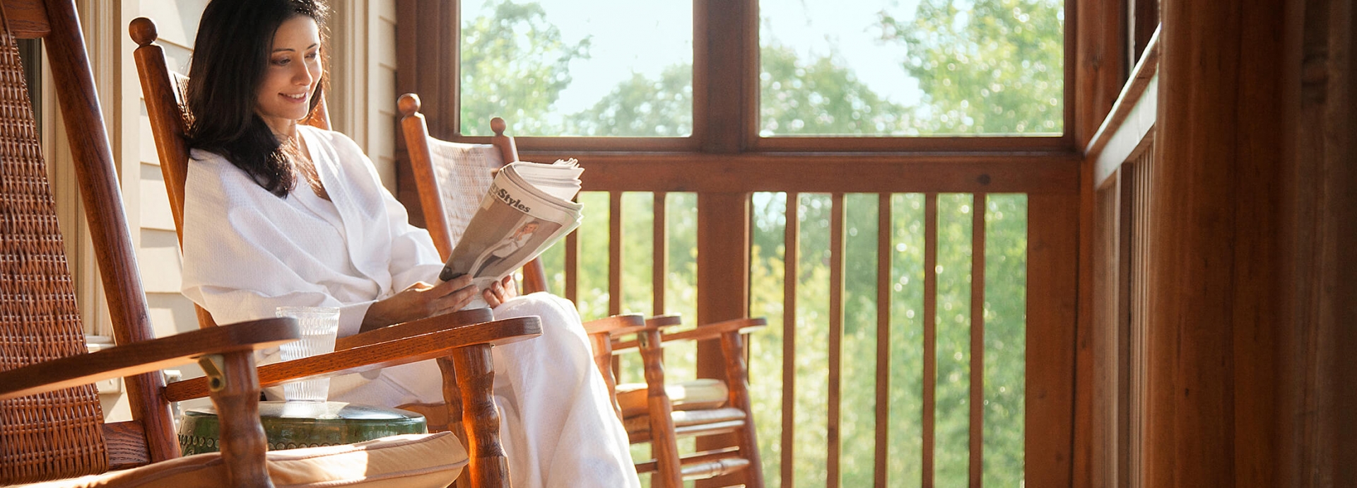 A Woman Reading the Paper on a Porch at Lake Austin