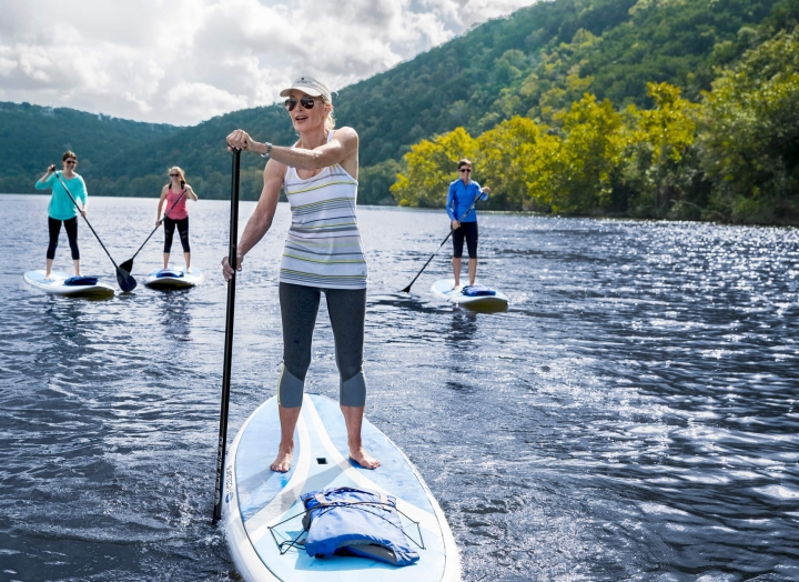 Stand Up Paddle Boarders Practicing Wellness
