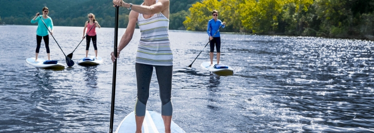 Stand Up Paddle Boarders Practicing Wellness
