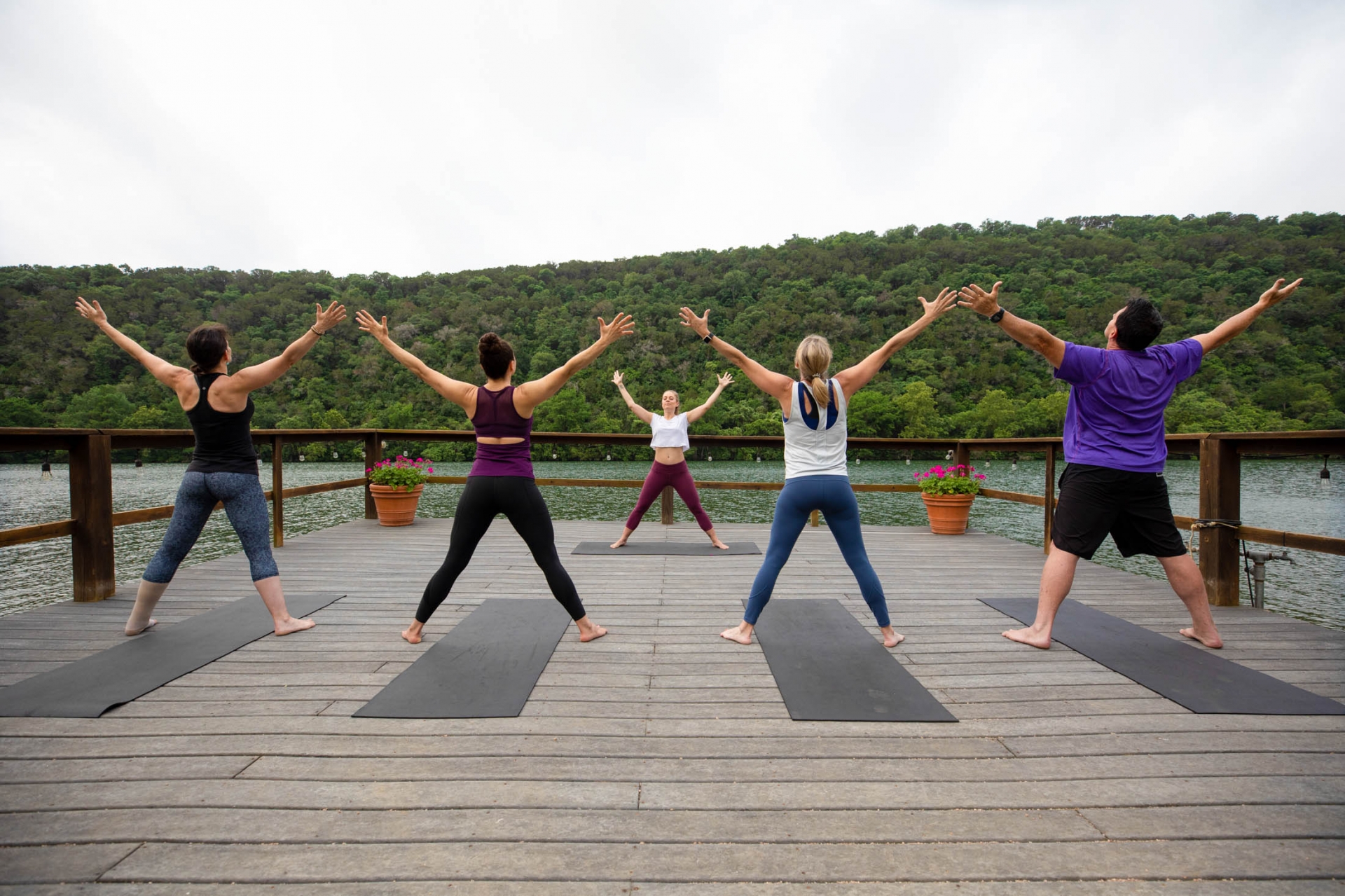 People doing yoga on the dock