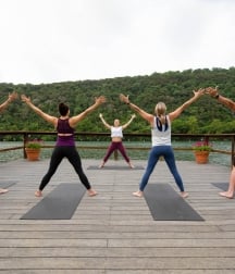 People doing yoga on the dock