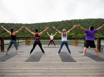 People doing yoga on the dock