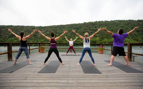 People doing yoga on the dock