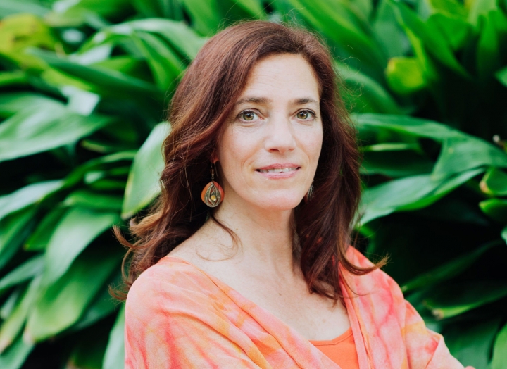 Wellness Expert Julie Haber sitting in front of the garden at Lake Austin Spa Resort.