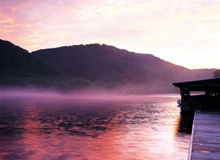 The docks of Lake Austin as the sun rises from behind the mountains