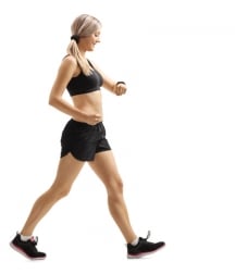 Full length profile shot of a woman walking and checking her sports watch isolated on white background