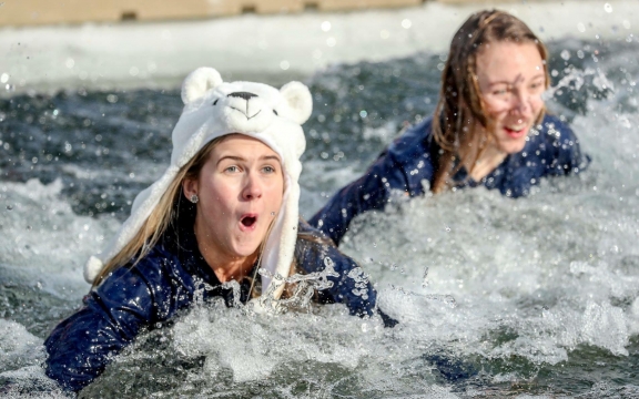 Two women completing the polar bear plunge at Lake Austin Spa Resort
