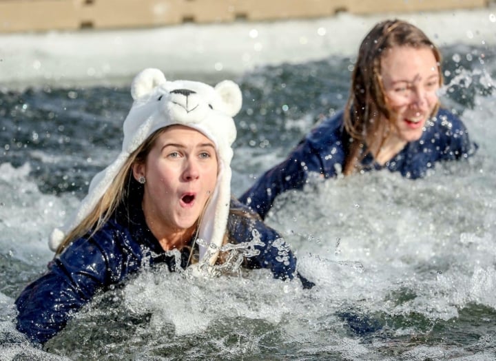 Two women completing the polar bear plunge at Lake Austin Spa Resort. 
