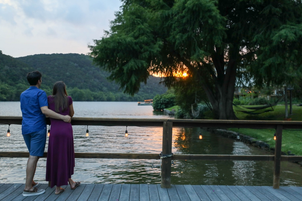 Couple watching sunset on dock