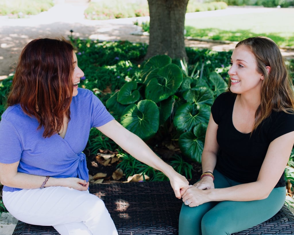 Two women talking on a bench