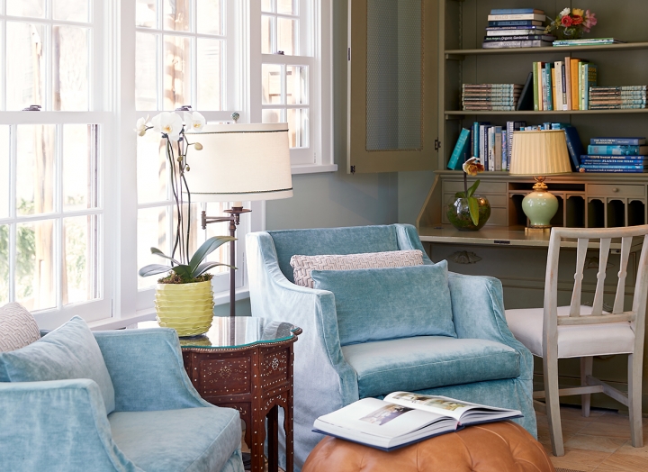Plush chairs and shelves of books inside of the library.