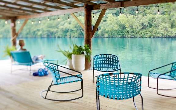 Turquoise lounge chairs gathered on the boat dock