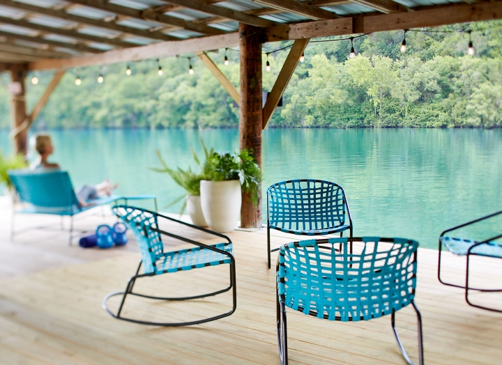 Turquoise lounge chairs gathered on the boat dock