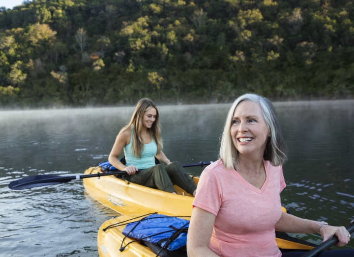 Mother and daughter kayaking at sunrise at Lake Austin Spa Resort