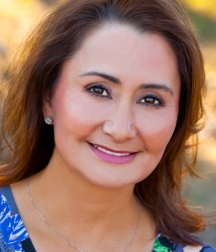 A lady with dark hair smiling at the camera