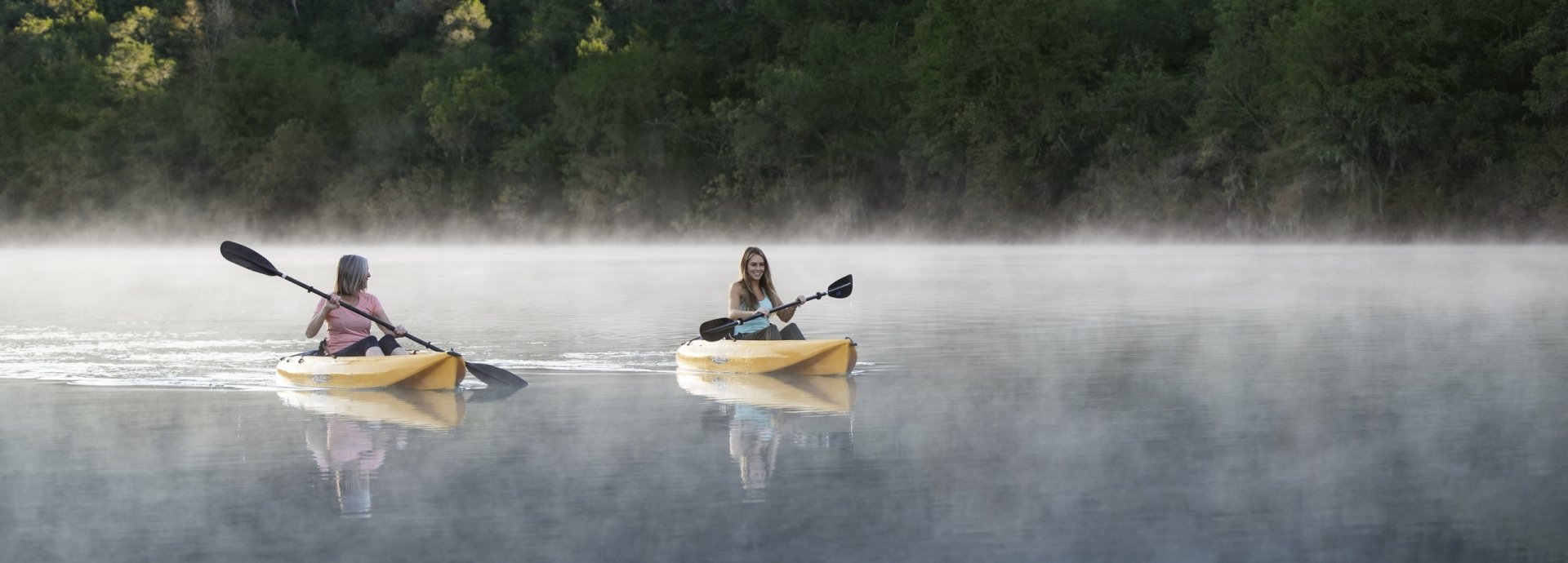 Mother and daughter kayaking at sunrise at Lake Austin Spa Resort
