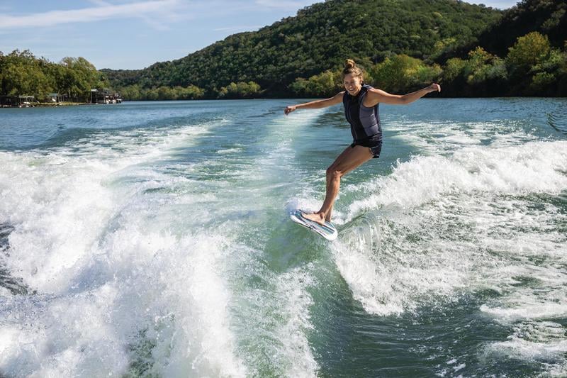 woman wakesurfing behind a boat