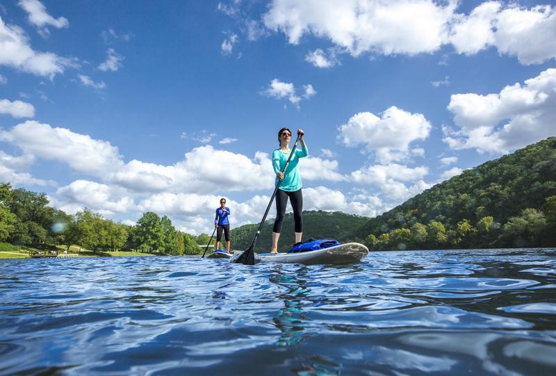 Two women on paddleboards on Lake Austin