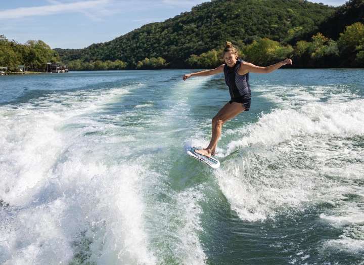 Woman wake surfing on Lake Austin