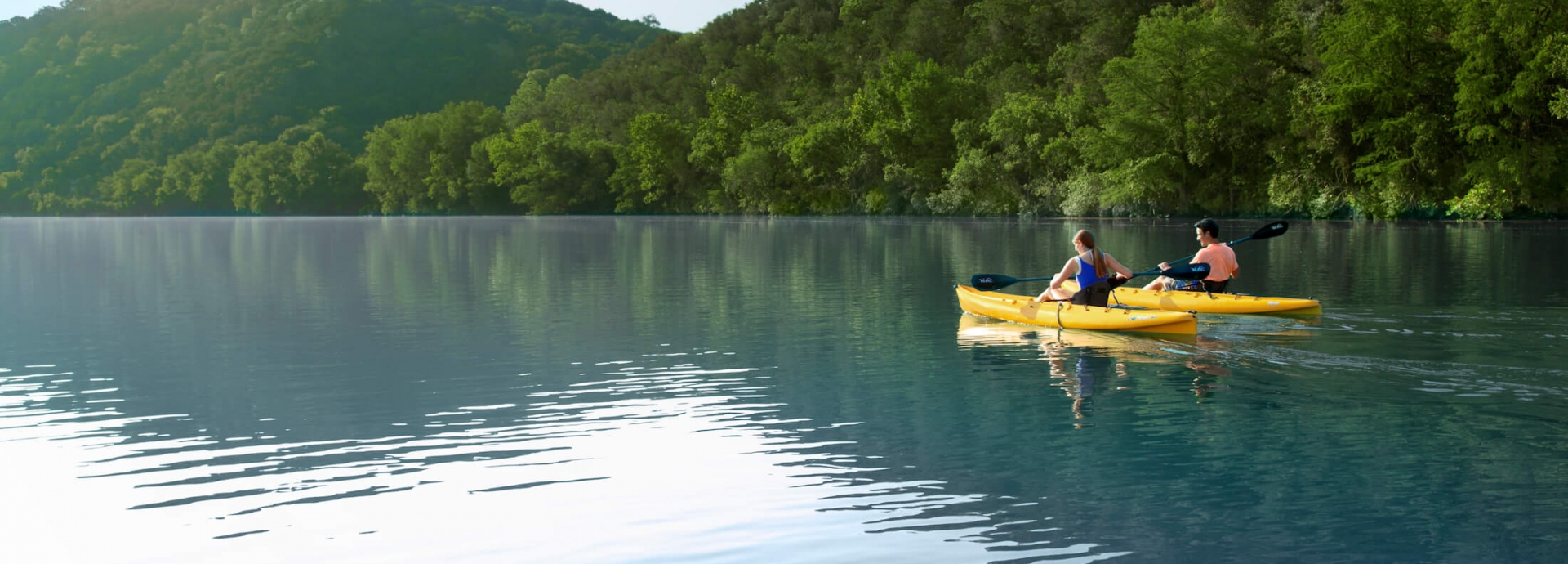 Two people kayaking in lake