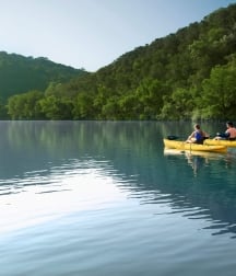 Two people kayaking in lake