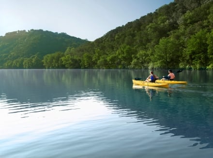 Two people kayaking in lake