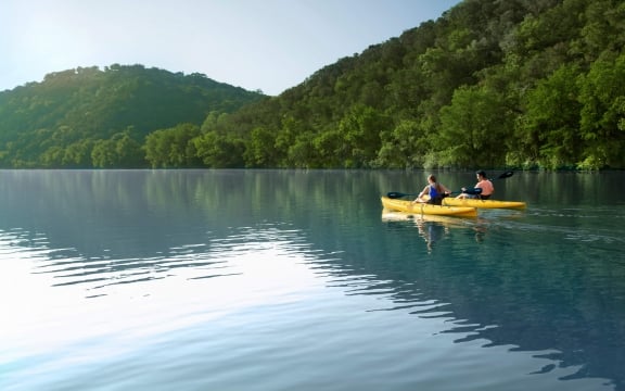Two people kayaking in lake