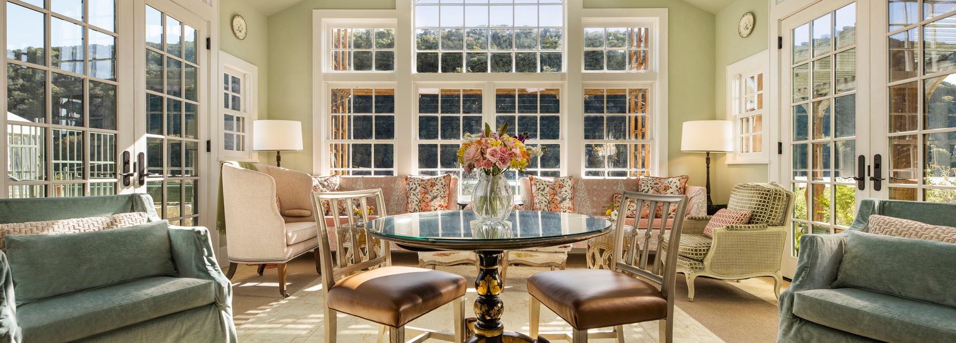 Inside of the garden library with sets of tables and chairs and beautiful flower arrangement