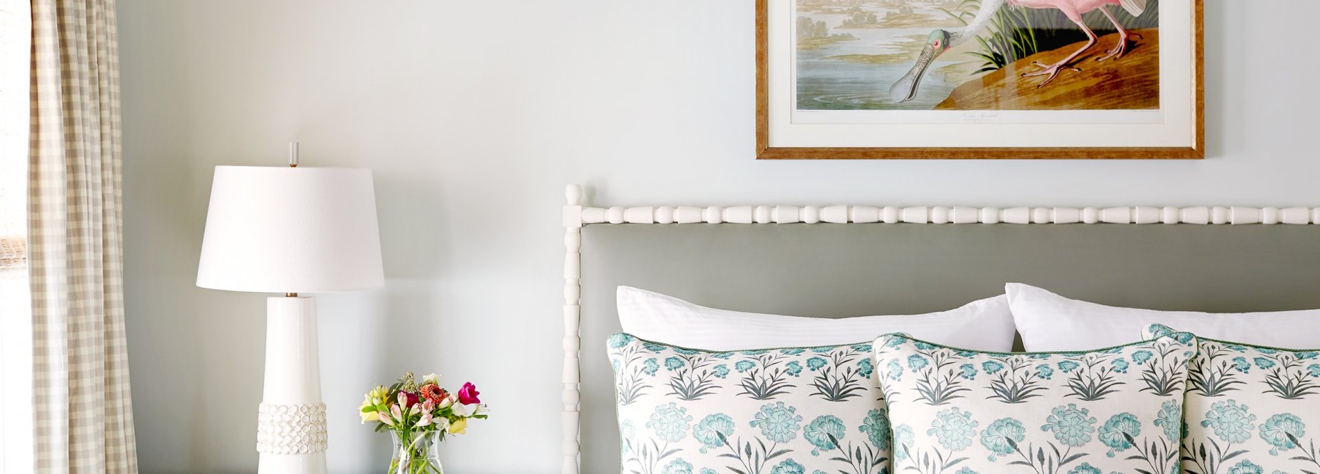 The bed in Premier Hot Tub Cottage with beautiful wall art of a crane