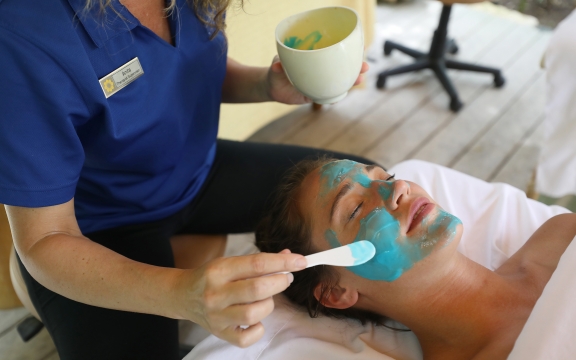 women applying blue facial spa