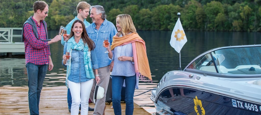 a group of people standing on a dock next to a boat