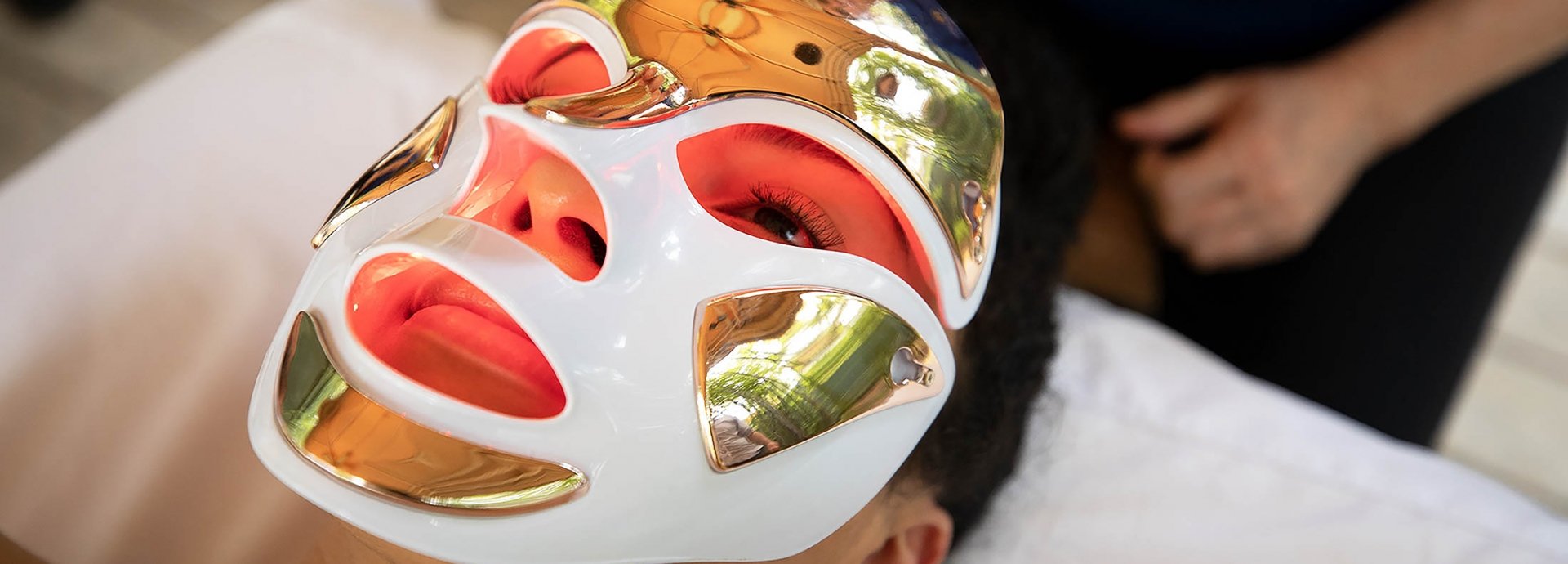 A woman receives a facial with a mask on