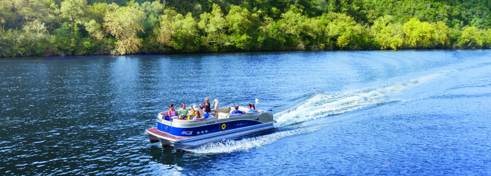 pontoon party boat cruising on Lake Austin