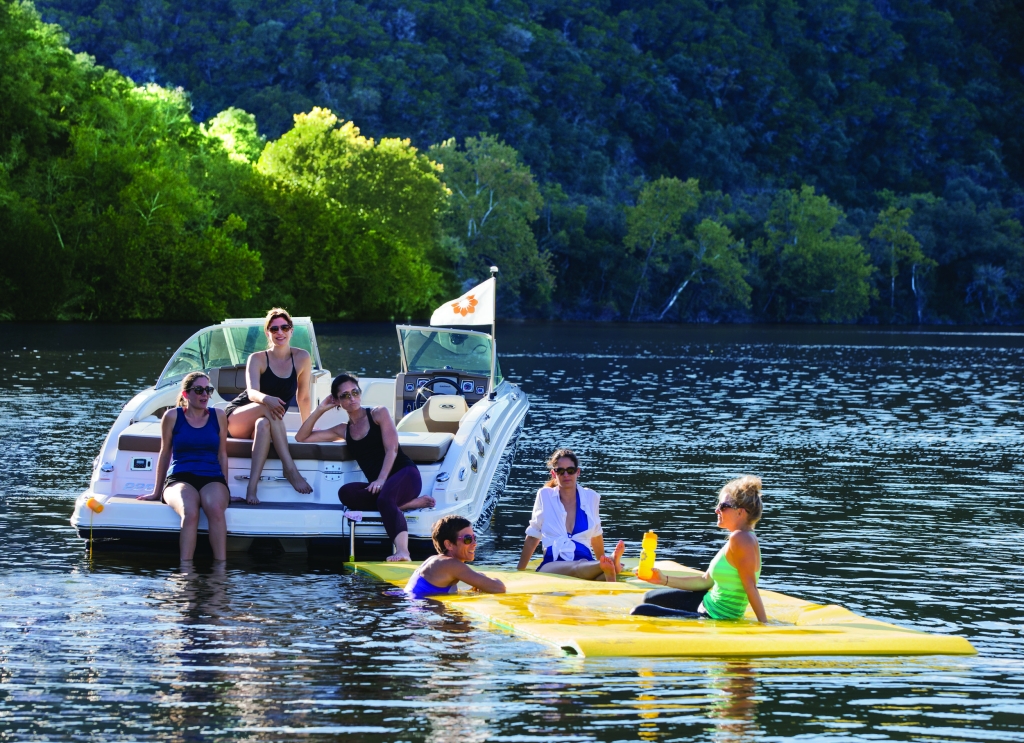 Water Mat and boat with women sitting and floating in water