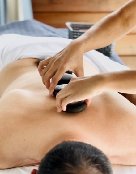 a person receiving a stone massage