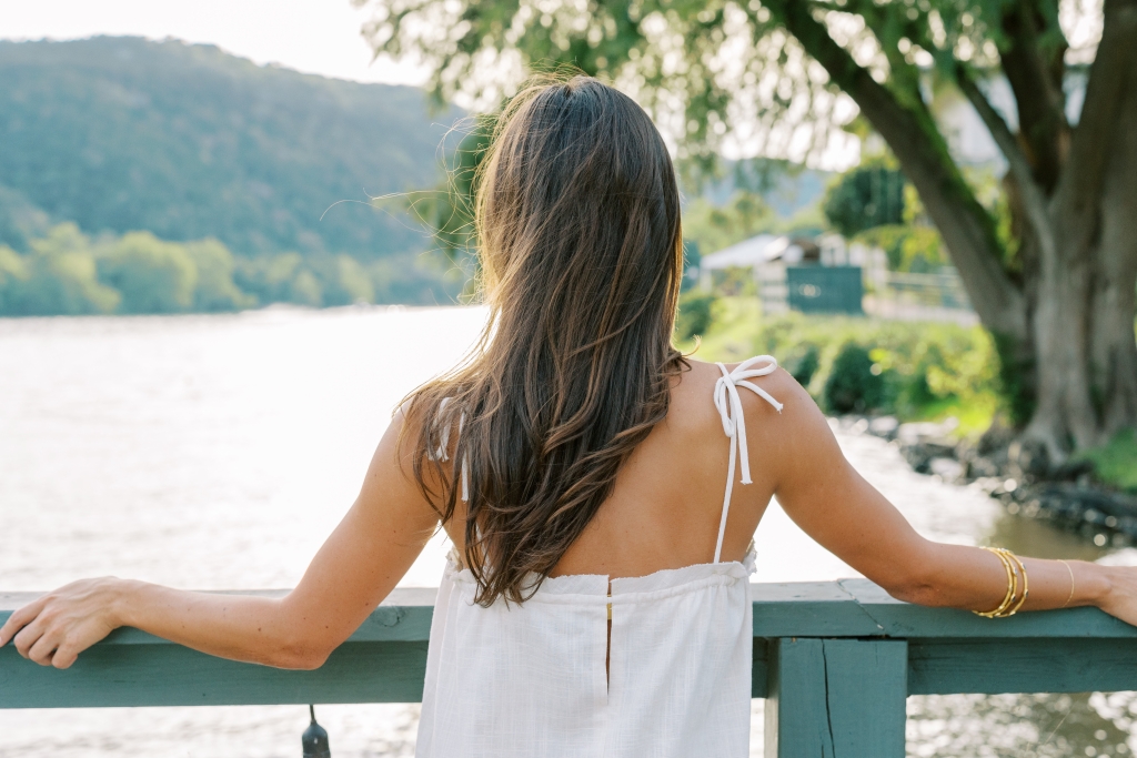 women standing looking towards the lake