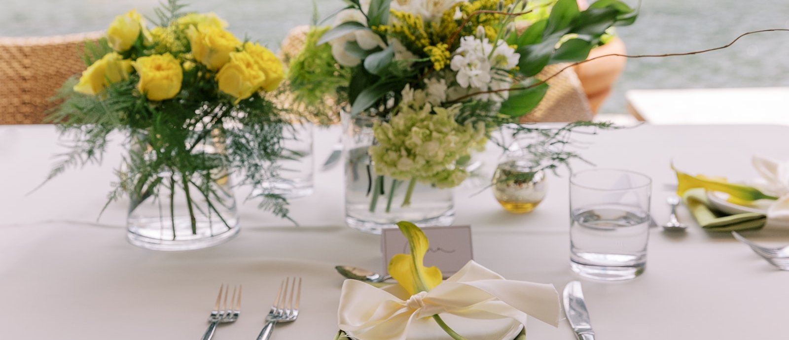 Flower arrange with neatly placed utensils by the lake