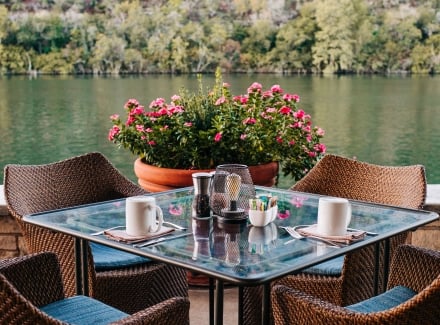 A set of one tables and chairs outdoor by the lake
