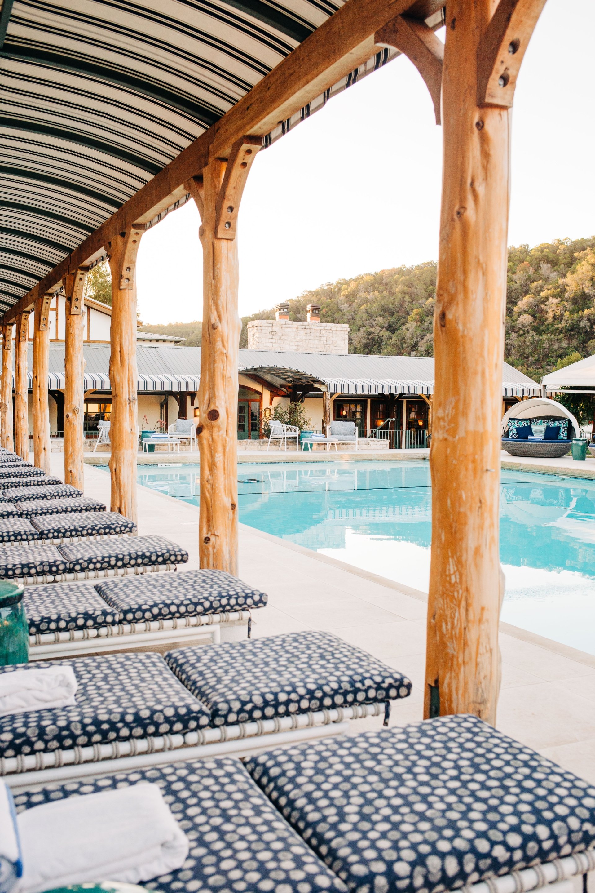 Bench overlooking the outdoor swimming pool, offering a relaxing spot to enjoy the view