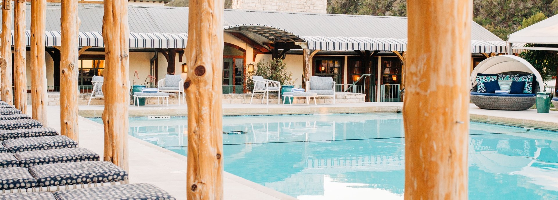 Bench overlooking the outdoor swimming pool, offering a relaxing spot to enjoy the view