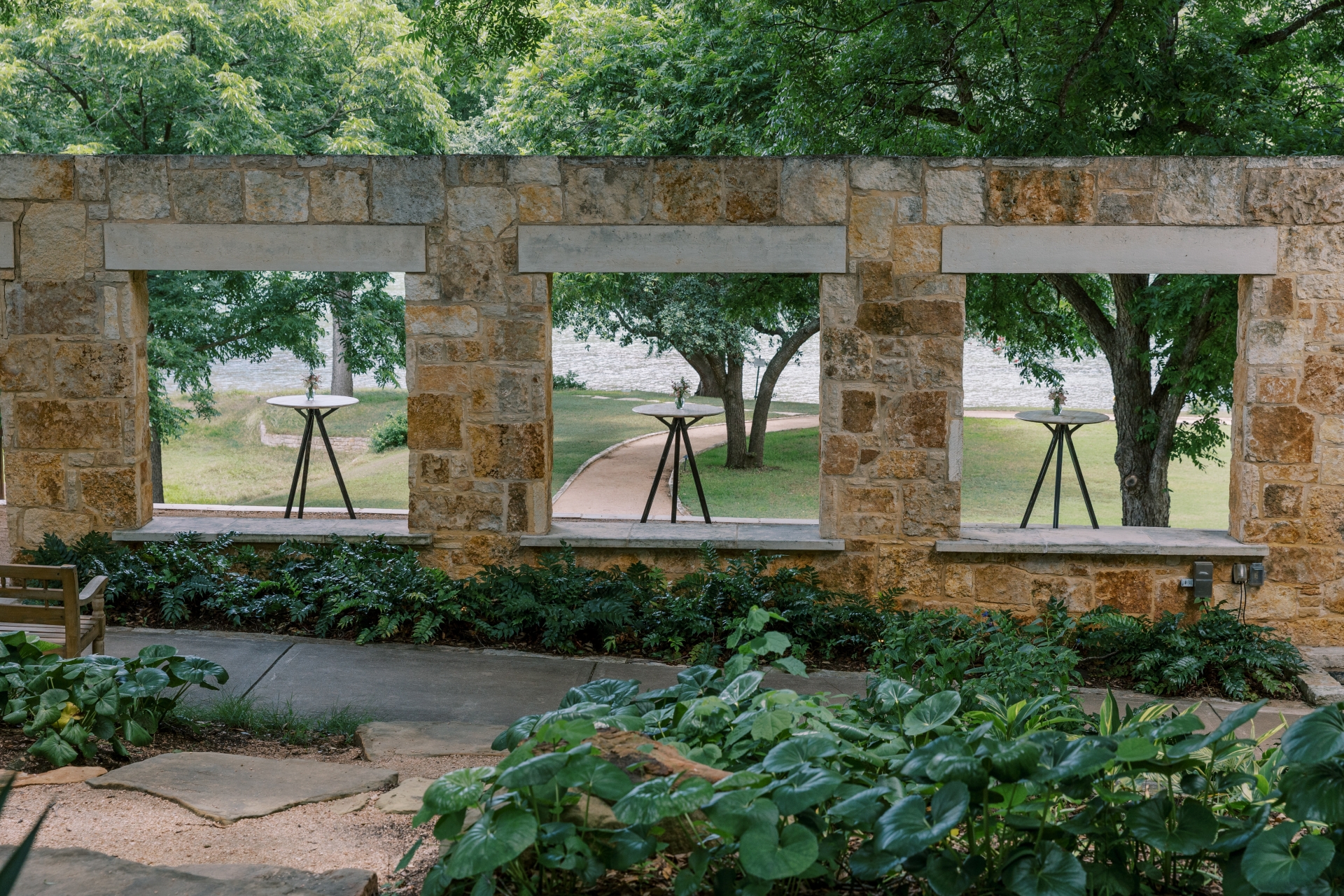 Three windows with a view of the lake and a setup of three tables