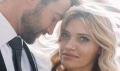 The groom looks at the bride warmly