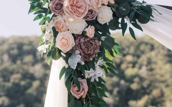 The floral arch is decorated with flowers in preparation for the wedding ceremony